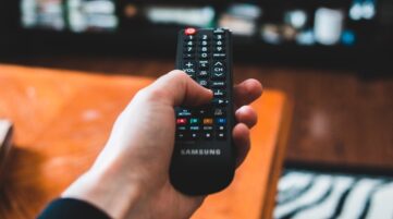 person holding black remote control